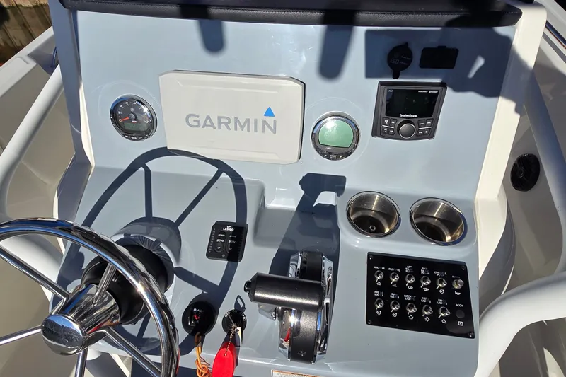 Slide: The Image of Dashboard of 2023 Bayliner Trophy T24CC with Garmin navigation and control panel. - 16