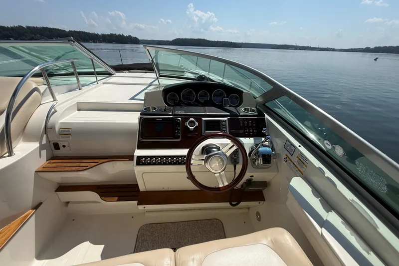 Slide: The Image of Cockpit of 2013 Sea Ray Sundancer 350 boat with steering wheel and control panel. - 26