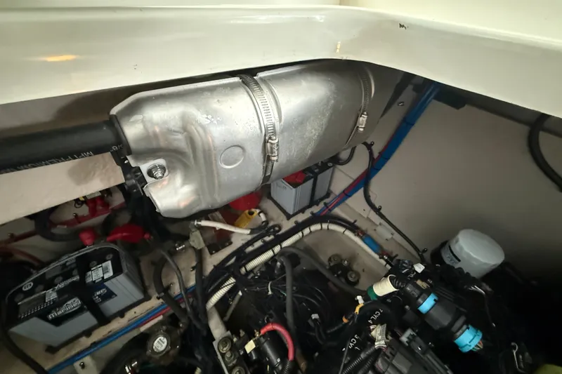 Slide: The Image of Engine compartment of a 2013 Sea Ray Sundancer 350, showcasing mechanical components and wiring. - 60