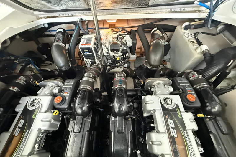 Slide: The Image of Engine compartment of a 2013 Sea Ray Sundancer 350, showcasing dual engines and mechanical components. - 56