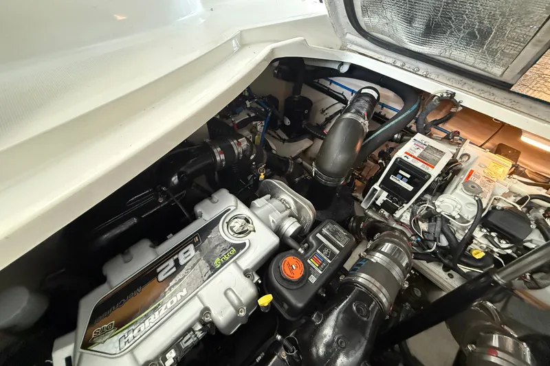 Slide: The Image of Engine compartment of a 2013 Sea Ray Sundancer 350, showcasing mechanical components and wiring. - 59