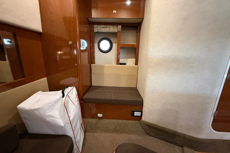 Slide: The Image of Interior of 2013 Sea Ray Sundancer 350 yacht with seating and porthole window. - 42