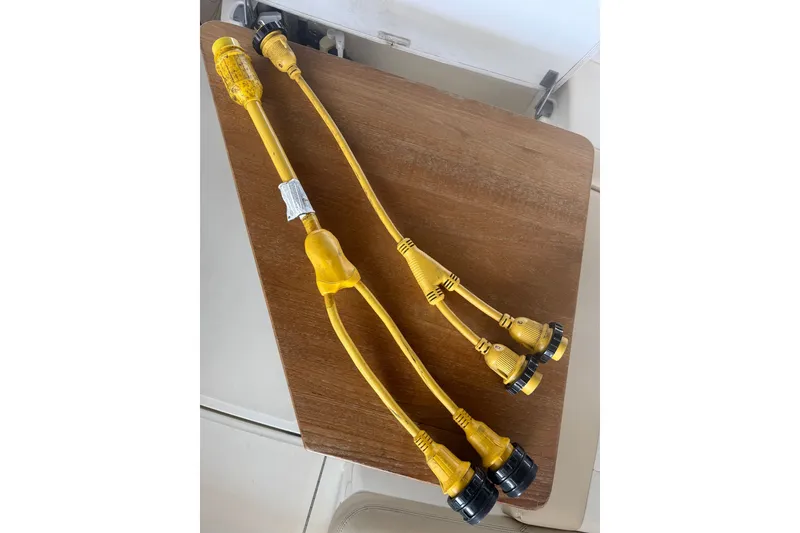 Slide: The Image of Yellow marine power cords on a wooden surface, suitable for Sea Ray Sundancer 350, 2013 model. - 49