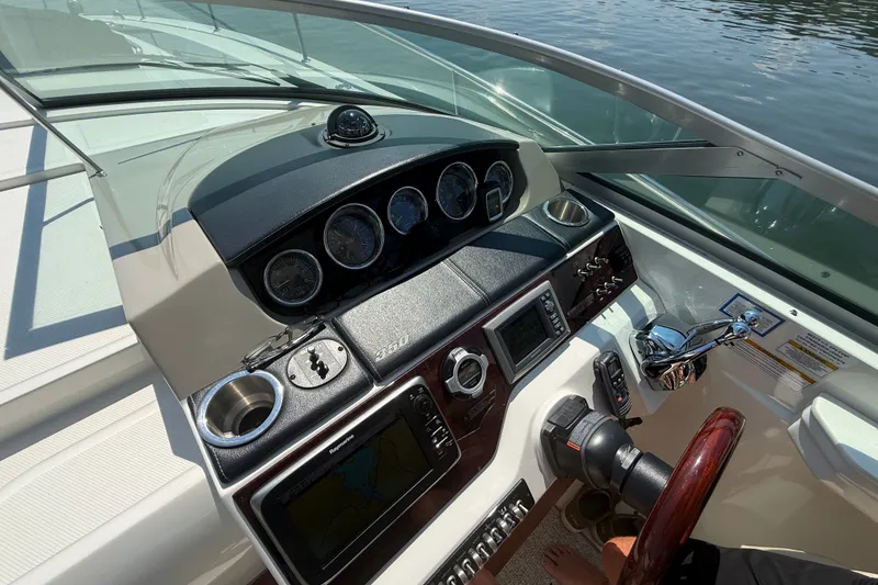 Slide: The Image of Cockpit of 2013 Sea Ray Sundancer 350 with navigation instruments and steering wheel. - 25