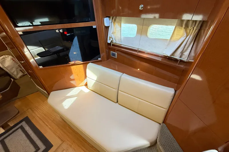 Slide: The Image of Interior of 2013 Sea Ray Sundancer 350 yacht with cream leather seating and wooden accents. - 37