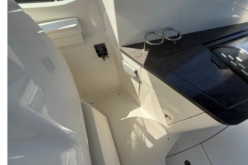 Slide: The Image of Interior view of 2013 Sea Ray Sundancer 350 yacht, featuring sleek countertops and storage. - 22