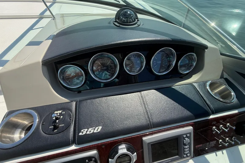 Slide: The Image of Dashboard of a 2013 Sea Ray Sundancer 350 boat with gauges and controls. - 29