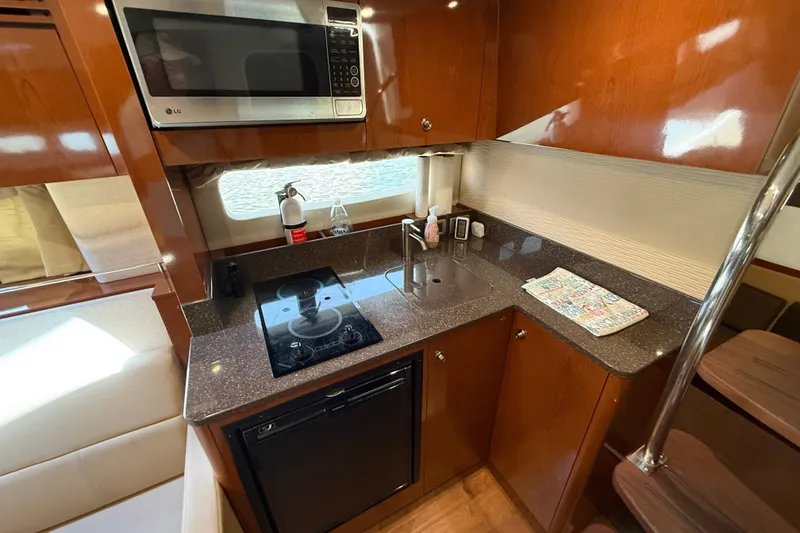 Slide: The Image of Luxurious 2013 Sea Ray Sundancer 350 yacht kitchen with modern appliances and sleek wood cabinetry. - 41