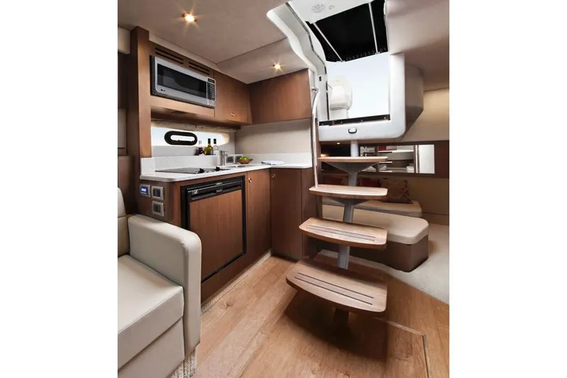 Slide: The Image of Manufacturer Provided Image: Interior of 2013 Sea Ray 350 Sundancer yacht with modern kitchen and wooden stairs. - 35