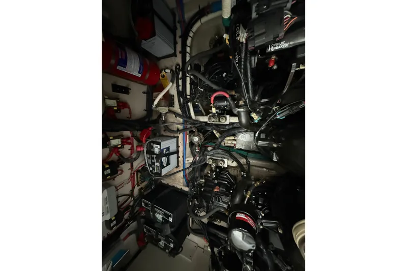 Slide: The Image of Engine compartment of a 2013 Sea Ray Sundancer 350 with visible wiring and components. - 58