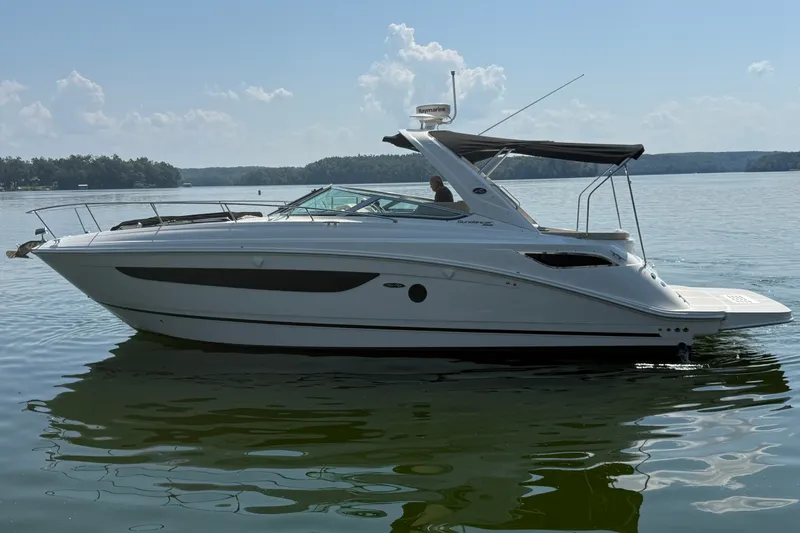 The Image of 2013 Sea Ray Sundancer 350 yacht on calm lake waters under a clear sky. - 0