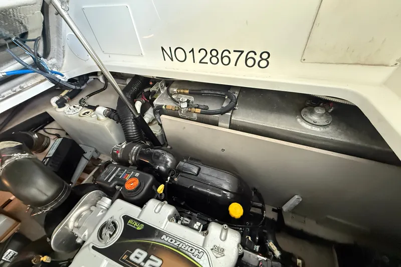Slide: The Image of Engine compartment of a 2013 Sea Ray Sundancer 350 boat, showcasing engine details. - 57