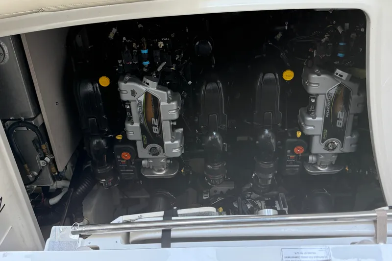 Slide: The Image of Engine compartment of a 2013 Sea Ray Sundancer 350 boat, showcasing dual engines. - 62