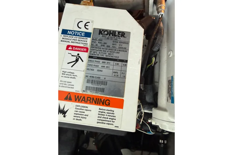 Slide: The Image of Kohler generator warning label on a 2013 Sea Ray Sundancer 350 boat engine. - 55