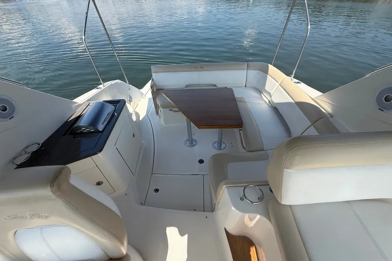 Slide: The Image of 2013 Sea Ray Sundancer 350 boat interior with seating and table on calm water. - 16