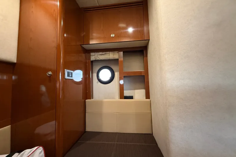 Slide: The Image of Interior cabin of 2013 Sea Ray Sundancer 350 yacht with wood paneling and porthole window. - 48