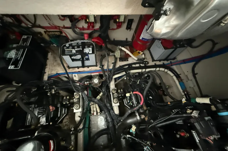 Slide: The Image of Engine room of a 2013 Sea Ray Sundancer 350 with visible wiring and components. - 61