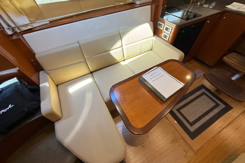 Slide: The Image of Interior of 2013 Sea Ray Sundancer 350 with beige seating and wooden table. - 39