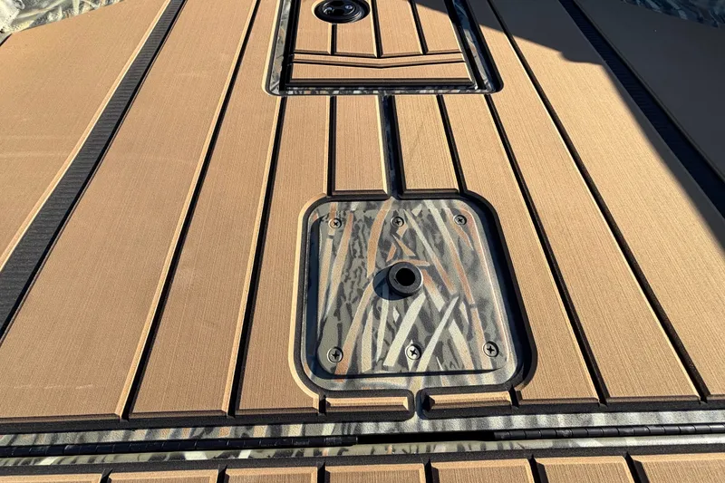Slide: The Image of Deck of 2027 Tracker Grizzly 1756 T Marsh boat with camo pattern and tan panels. - 15