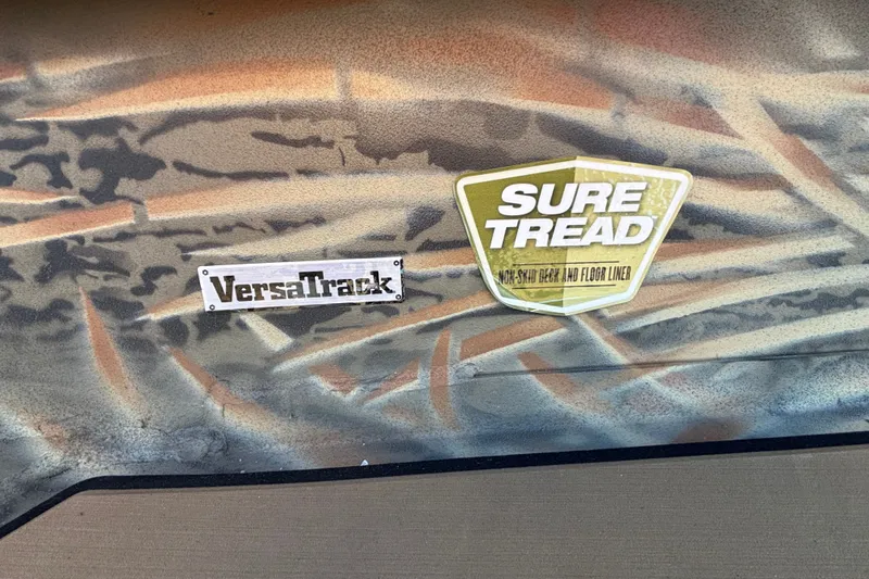 Slide: The Image of Camouflage design on Tracker Grizzly 1756 T Marsh 2027 with VersaTrack and Sure Tread logos. - 19