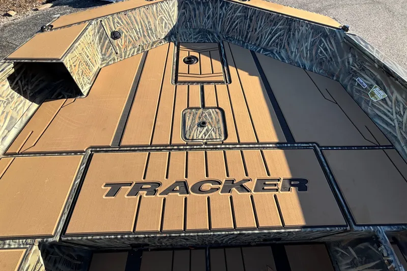 Slide: The Image of 2027 Tracker Grizzly 1756 T Marsh boat interior with camo design and logo. - 13