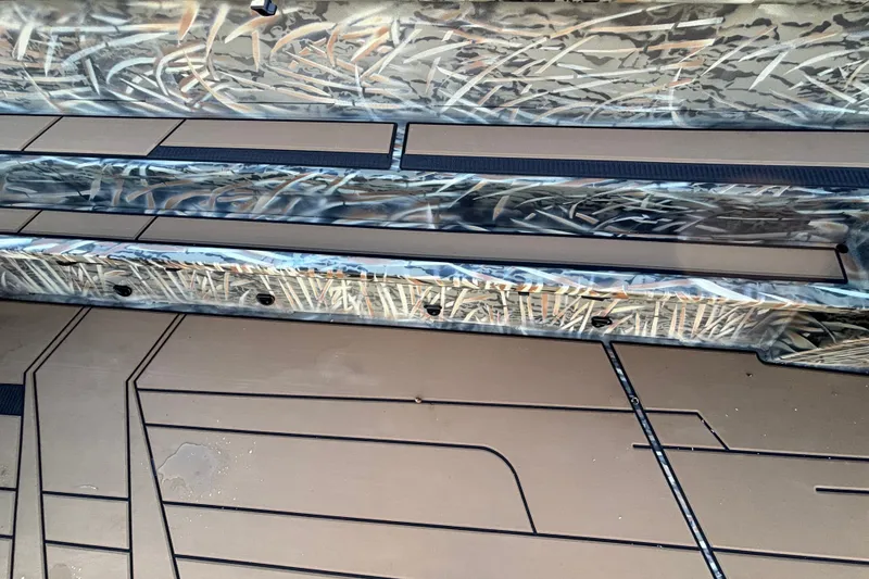 Slide: The Image of Interior view of 2027 Tracker Grizzly 1756 T Marsh boat with camouflage design. - 20