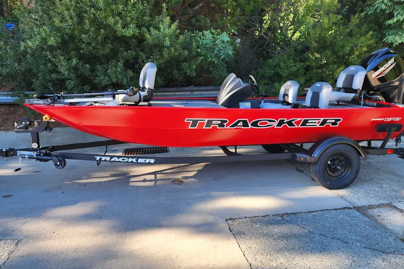 The Image of Red 2027 Tracker Pro 170 boat on trailer, parked outdoors. - 0