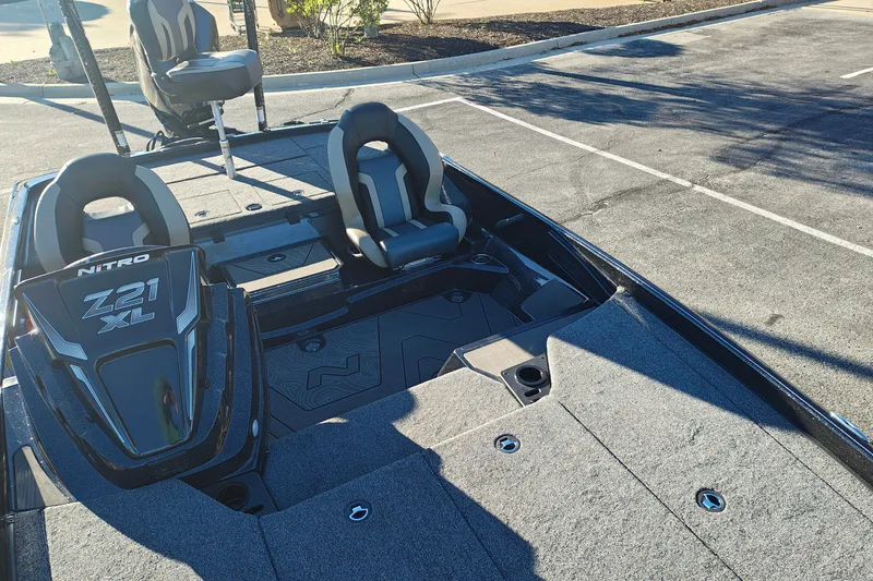 Slide: The Image of 2027 Nitro Z21 XL Pro boat with sleek design and comfortable seating in a parking lot. - 44