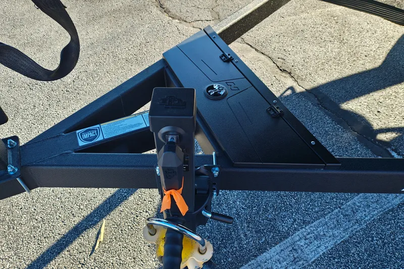 Slide: The Image of Trailer hitch of 2027 Nitro Z21 XL Pro on asphalt, featuring Impact branding. - 3
