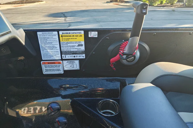 Slide: The Image of 2027 Nitro Z21 XL Pro boat cockpit with controls, warning labels, and seating. - 19