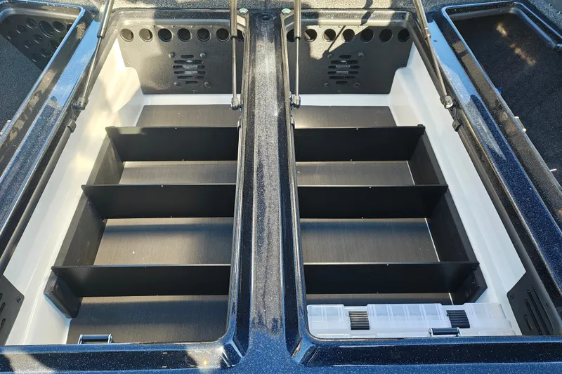 Slide: The Image of 2027 Nitro Z21 XL Pro boat storage compartments with organized shelving and tackle box. - 28