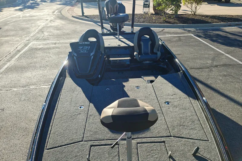 Slide: The Image of 2027 Nitro Z21 XL Pro boat with seating, parked on pavement in sunlight. - 33