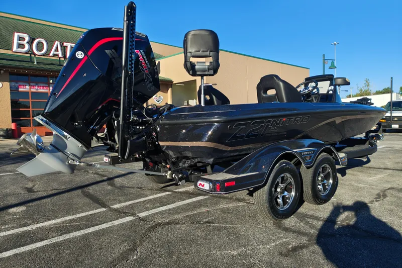 Slide: The Image of 2027 Nitro Z21 XL Pro boat with powerful engine, parked outside a boating store. - 10