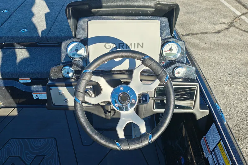 Slide: The Image of 2027 Nitro Z21 XL Pro boat dashboard with Garmin display and steering wheel. - 13