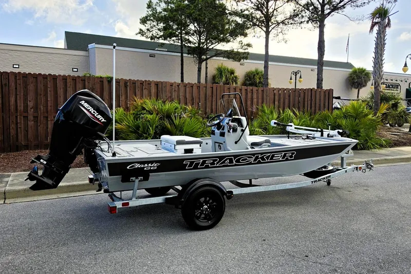 The Image of 2027 Tracker Bass Tracker Classic CC boat on trailer, parked outdoors. - 0