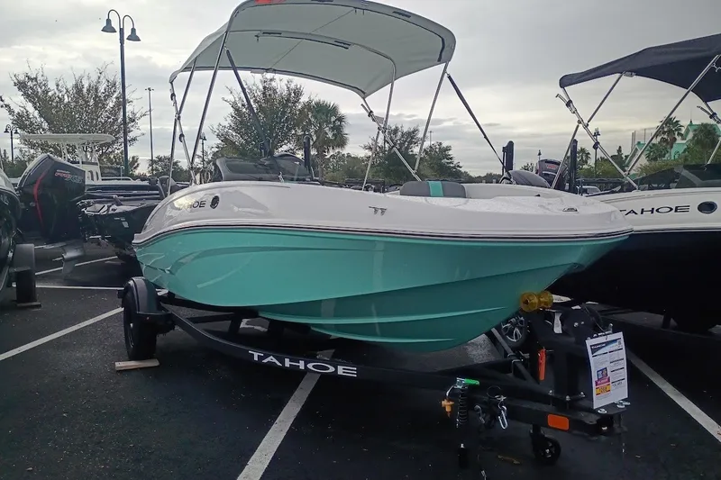 Slide: The Image of 2027 Tahoe T16 boat with canopy on trailer in parking lot. - 1