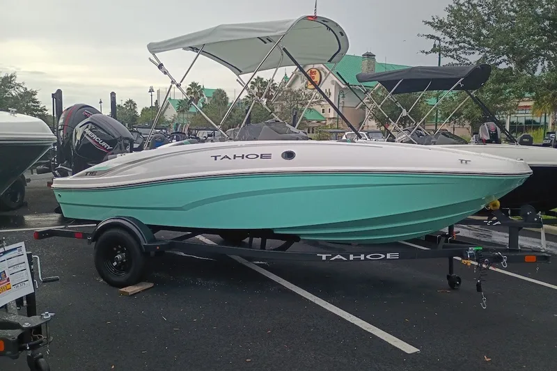 Slide: The Image of 2027 Tahoe T16 boat with canopy on trailer in parking lot. - 2