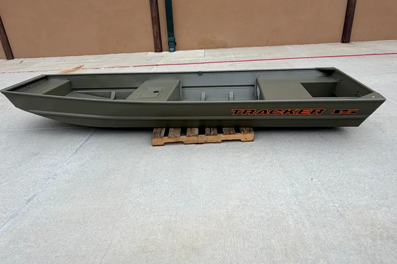 The Image of 2027 Tracker Grizzly 15 Jon boat on a wooden pallet, displayed outdoors. - 0