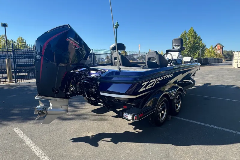 Slide: The Image of 2027 Nitro Z21 XL Pro boat with powerful outboard motor in a parking lot. - 3
