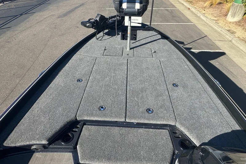 Slide: The Image of 2027 Nitro Z21 XL Pro boat deck with gray carpeting and fishing equipment. - 10