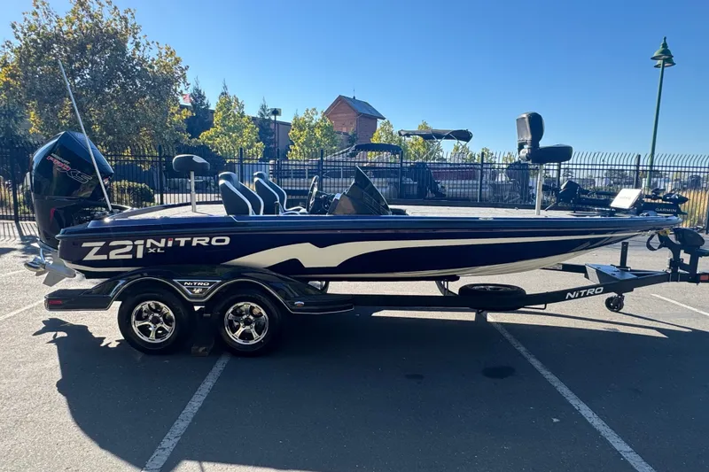 Slide: The Image of 2027 Nitro Z21 XL Pro boat parked outdoors on a sunny day. - 6
