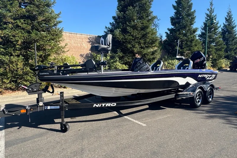 Slide: The Image of 2027 Nitro Z21 XL Pro boat on trailer, parked outdoors, featuring sleek design and modern equipment. - 2