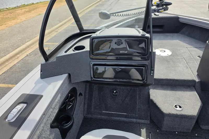 Slide: The Image of 2027 Tracker Targa V-18 WT boat interior with storage compartments and carpeted flooring. - 14