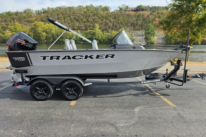 Slide: The Image of 2027 Tracker Targa V-18 WT boat on trailer by a scenic river. - 15