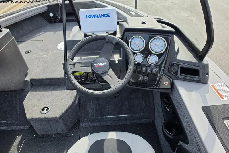 Slide: The Image of 2027 Tracker Targa V-18 WT boat dashboard with steering wheel and gauges. - 13