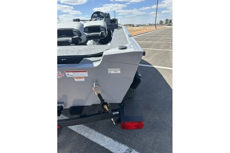 Slide: The Image of 2027 Tracker Super Guide V-16 SC boat rear view in parking lot. - 39