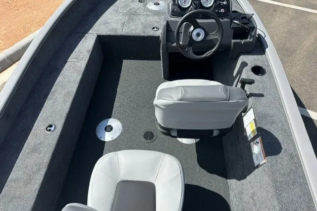 Slide: The Image of 2027 Tracker Super Guide V-16 SC boat interior with steering console and seating. - 13