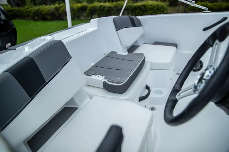 Slide: The Image of 2027 Tahoe T18 boat interior with sleek seating and modern steering wheel design. - 10