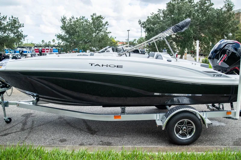 Slide: The Image of 2027 Tahoe T18 boat on trailer, parked outdoors, showcasing sleek design and modern features. - 5