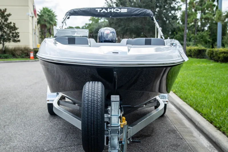 Slide: The Image of Front view of a 2027 Tahoe T18 boat on a trailer, parked outdoors. - 3